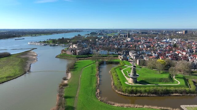 Historic fortified city with traditional windmill and waterfront in Europe