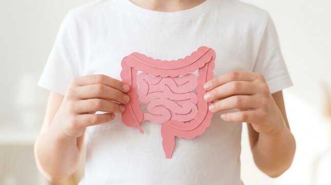 A child holding a pink intestine cutout for leaky gut and probiotic digestive health concepts.
