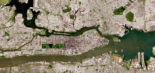 Aerial satellite view of New York City, Manhattan and surrounding boroughs with visible urban grid, rivers, bridges and coastal landscape in the USA © M. Jurzyk