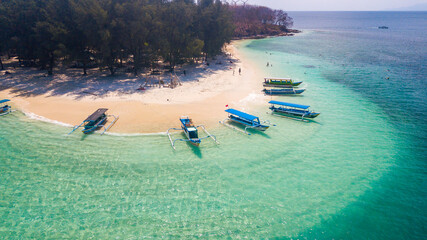 Fototapeta premium Aerial View of Tropical Gili Island Beach with Traditional Outrigger Boats
