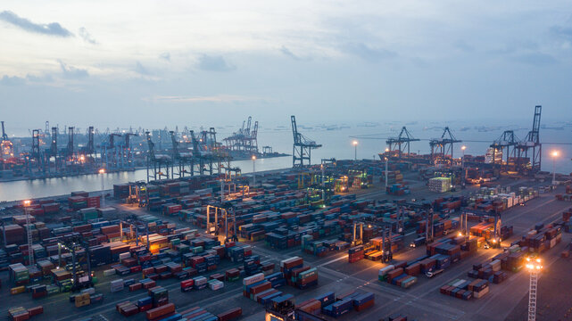 Aerial View of Global Logistics Container Port Illuminated at Dawn