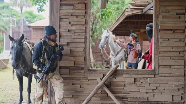 Group of men with combatant and Arab style stay in the old building and discuss about plan to fight with enemy.