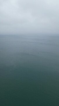 Aerial View of Teignmouth Beach and Ocean Town of England United Kingdom. High angle Vertical Footage Was Captured with Drone Camera During Windy and Rainy clouds over British Tourist Attraction of UK