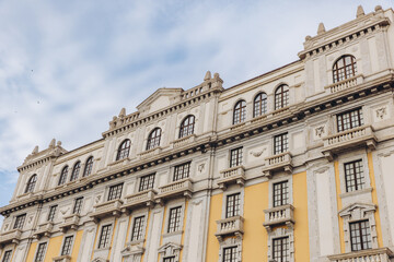Fototapeta premium Cagliari historical architecture featuring ornate facade details, arched windows, and decorative balconies under a summer sky