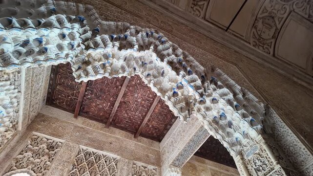 Intricate Moorish decorations cover the walls and ceilings of the Alhambra Palace, Granada, Andalusia, Spain.