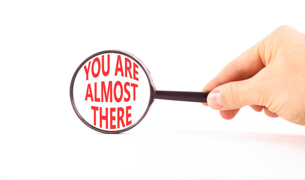 You are almost there words symbol. Concept words You are almost there on beautiful magnifying glass. Beautiful white background. Business You are almost there motivational support concept. Copy space.