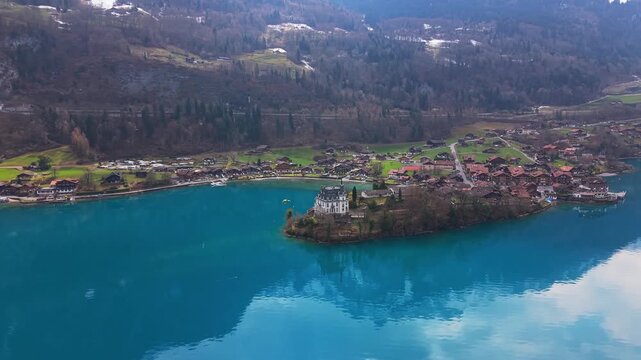Droneshot of the clear Lake Brienzersee at Iseltwald, canton Bern in Switzerland during Spring.