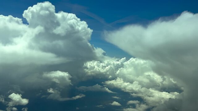 pilot POV flying between towering cumulonimbus strom clouds in a blue sky, doing some turns to avoid turbulence. 120000m high.