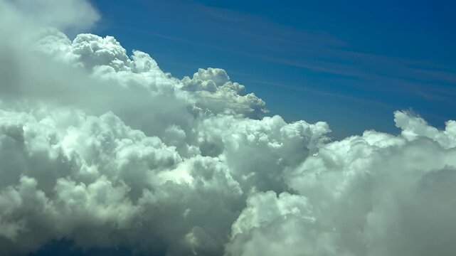 Pilot POV flying in a turbuelnt sky with threatening storm clouds ahead under a blue sky. scene captured at 12000m high rom a jet airplane.