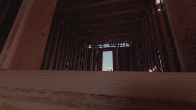 Wide angle slow downward glide revealing interior wooden framing details.