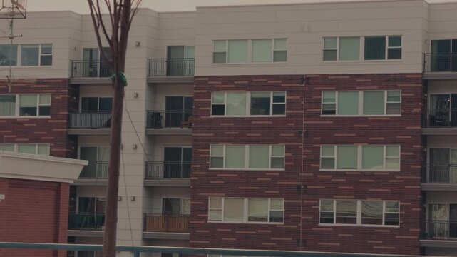 Cinematic glide and pan across modern residential building with balconies