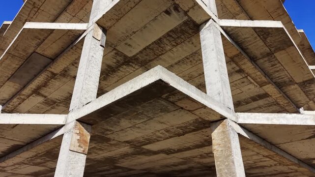 Detailed view of reinforced concrete building elements showing texture and structural design. Close up architectural detail of concrete slabs and columns.