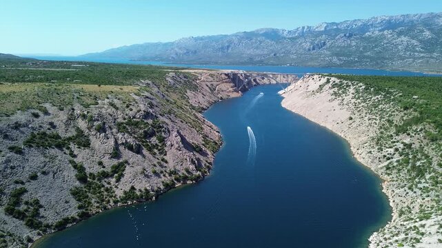 Cinematic aerial pull back and reveal shot of sea bay with bridge and mountains in Croatia 