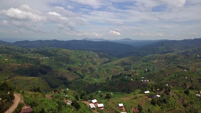 Hillside smallholder farmland with mixed crops and scattered villages in Kanungu District Western Region Uganda within Kigezi Highlands showing intercropping and ridge valley agriculture drone forward