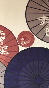 A close-up view of several traditional Japanese umbrellas with intricate floral patterns.
