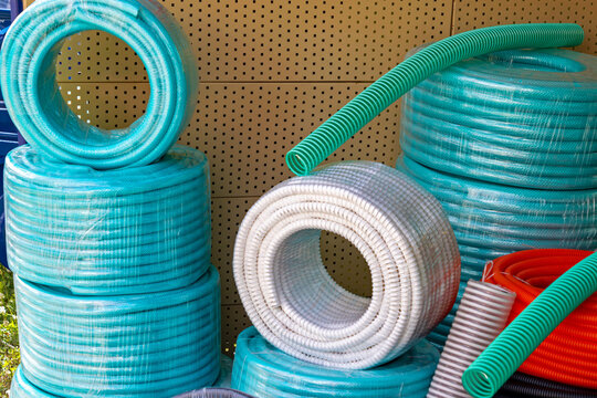 Colorful plastic gardening water pipes rolled in circle sold on market