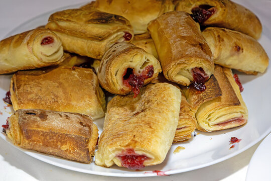 Pile of sweet homemade cherry pie desserts on a ceramic plate