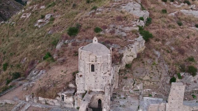 Drone on an ancient tower in Amantea, Italy. On a high hill on the seashore above the city. A cloudy summer day