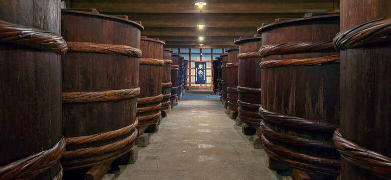 Traditional Wooden Fermentation Barrels in Japanese Brewery Warehouse