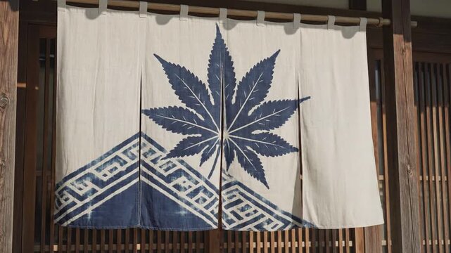 Traditional Japanese noren curtain with indigo blue maple leaf pattern hanging at entrance to wooden building