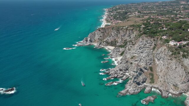 Drone over the historic lagoon with boats and yachts. Capo Vaticano in the Municipality of Ricadi in Calabria, Italy. Sunny summer day.