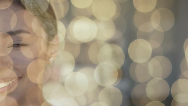 Close-up starting, woman opening eyes and smiling amid warm bokeh lights for portrait photography