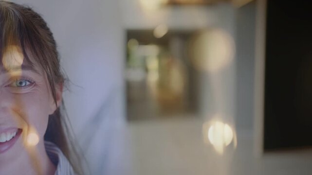 Woman holding eye contact in corridor, bokeh shifting across face for business portrait
