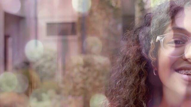 Teen girl responding to cue, smiling and revealing braces for marketing, bokeh framing face