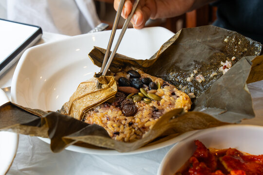 Using Chopsticks to Open Healthy Korean Lotus Leaf Wrapped Rice