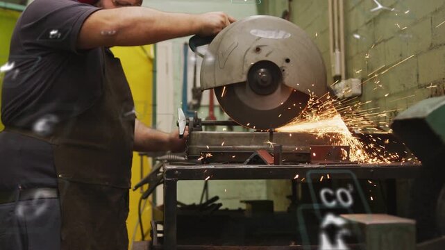 Male machinist starting wheel, cutting part for assembly, sparks flying, UI tracking cut in shop