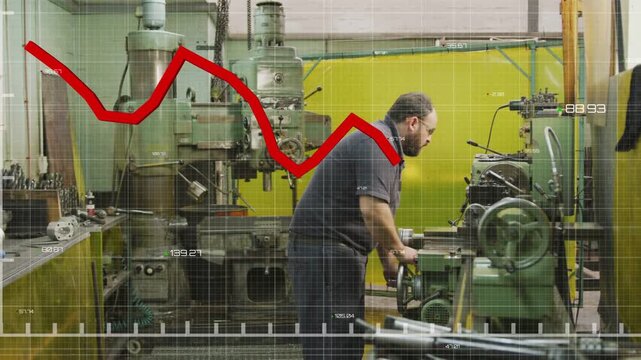 Operator using wheel at lathe in metal shop tuning feed checking spindle while red graph overlaying