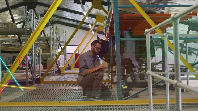 Tech squatting on grate inspecting rack, tapping tablet making neon waves for industrial audit