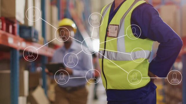 Warehouse worker holding lower back, activating node map showing strain, co-worker checking tablet