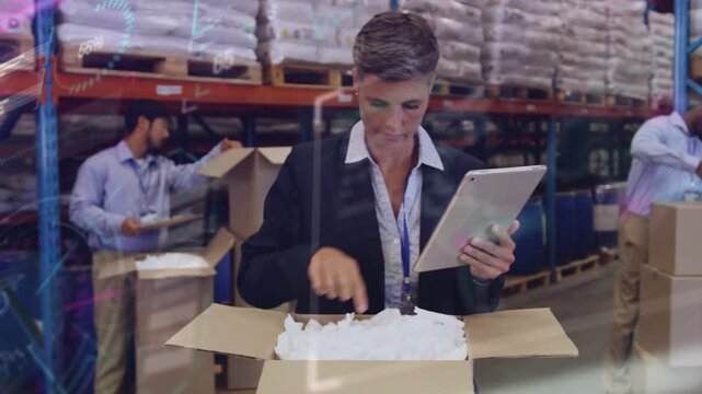 Supervisor tapping tablet and inspecting open box, confirming packing quality for warehouse