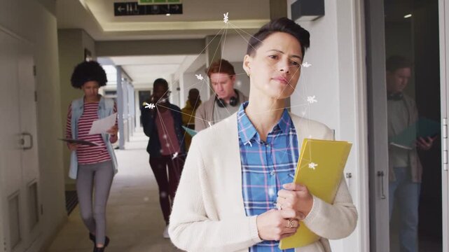Woman with yellow folder sparking nodes around head, walking corridor, leading peers to class