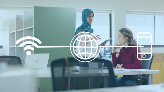 Standing woman tapping tablet explaining to colleague in tech reviewing papers, WiFi icons floating