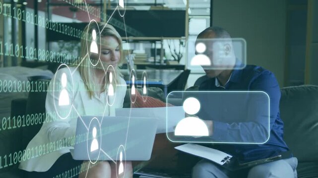 Two pros reviewing laptop and papers for network discussion, binary overlay fading in linking data