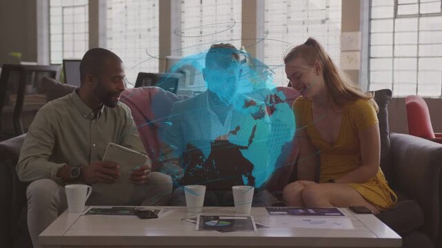 Center man adjusting laptop and gesturing, causing rotating globe, business team working on pitch