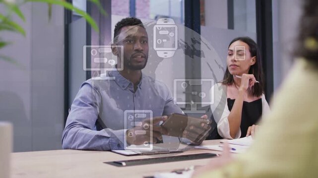 Man turning tablet toward other, pitching globe tech icons fading over speakers, handshake closing