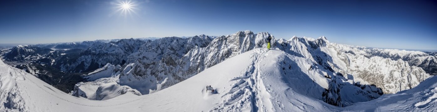 Alpine panorama at the Alpspitz summit, ski tourers on ski tour to the Alpspitze, Bernadeinkopf, view over the Wetterstein mountains with snow in winter, Garmisch-Partenkirchen, Bavaria, Germany