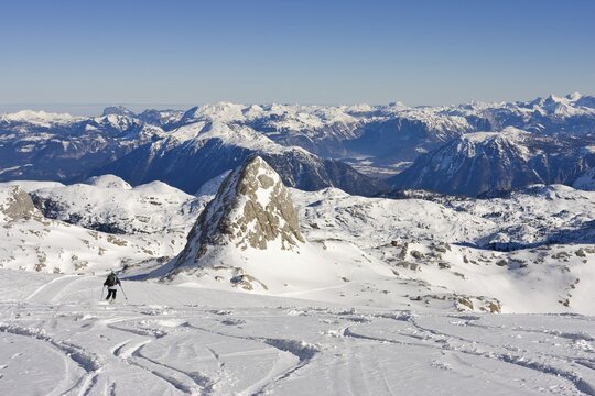 Woman skiing across the Dachstein Glacier, Mt. Schoeberl (2426 m or 7959 ft) and Simony Cabin to the right, Dachstein Massif, Styria, Austria, Europe