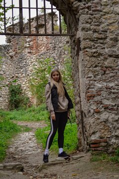 Young woman walking along a charming path through historic ruins in Samobor, Croatia. This scenic and romantic European destination is known for its preserved heritage and natural beauty.