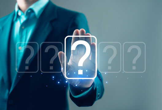 Businessman selecting digital question mark interface, decision making, problem solving, uncertainty and business strategy concept with futuristic technology and virtual options display