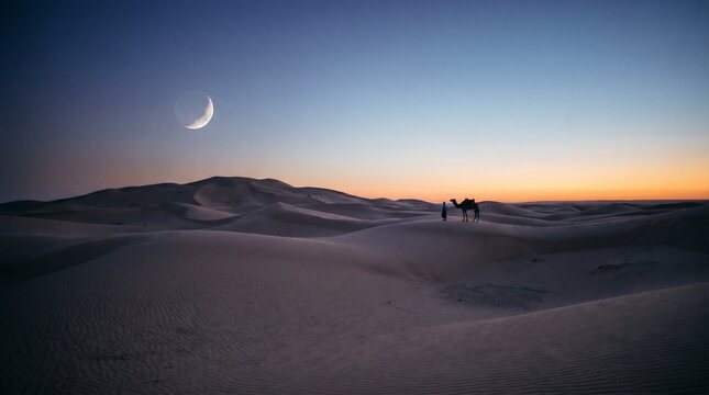 Crescent moon rising over vast desert sand dunes with silhouette of camel and nomad at sunset