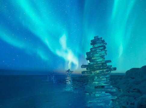 Beautiful winter landscape of frozen Lake Baikal with Aurora Borealis - Snowy ice hummocks with transparent blue piles of ice - Baikal Lake, Siberia