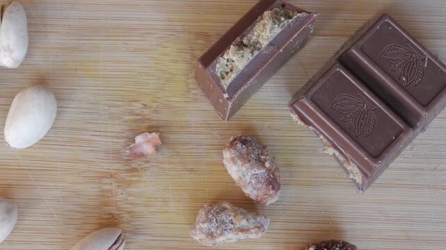 Dubai chocolate bar with nuts on a wooden board in natural light