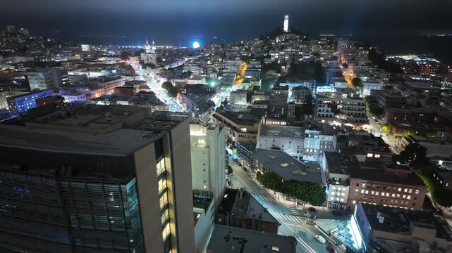 An elevated time-lapse view captures the vibrant pulse of North Beach and Coit Tower, as city lights flicker and traffic flows through San Francisco&rsquo;s layered nighttime skyline