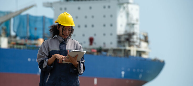 Female maritime engineer using digital tablet for logistics management