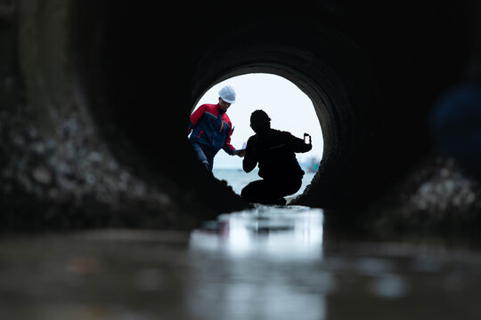 Industrial inspector monitoring wastewater drainage tunnel