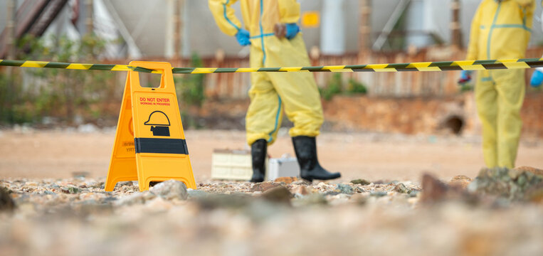 Warning sign and restricted area barrier at hazardous environmental cleanup site